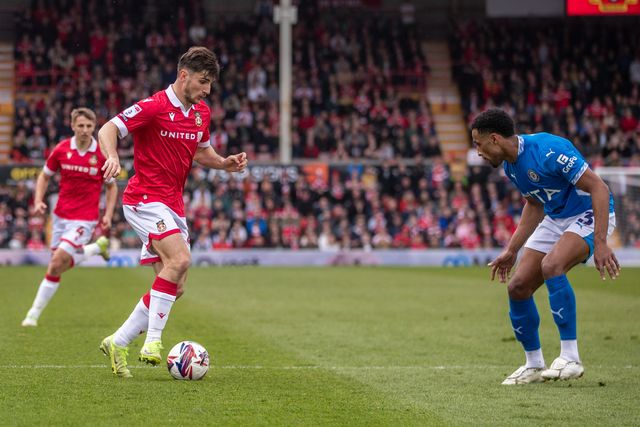 Wrexham's Ryan Longman takes on Stockport County's Ibou Touray during the Sky Bet League 1 match Wrexham vs Stockport County at SToK Cae Ras, Wrexham, United Kingdom, 22nd March 2025

(Photo by Nik Mesney/News Images)