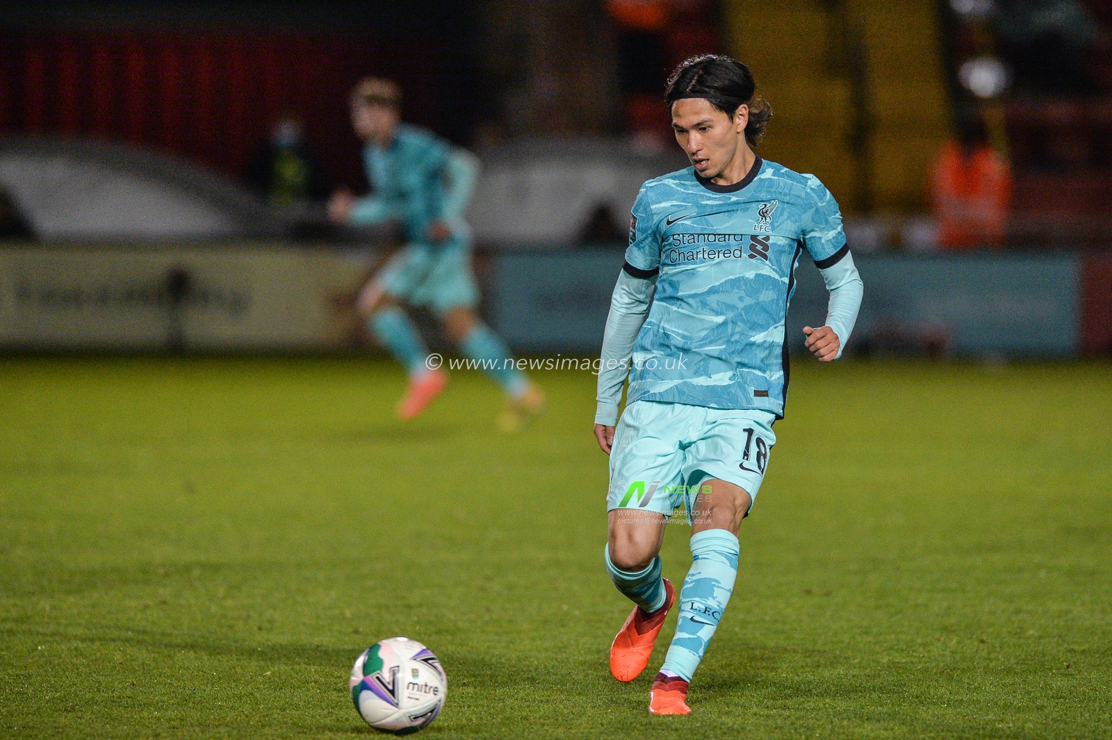 Takumi Minamino (18) of Liverpool in action.