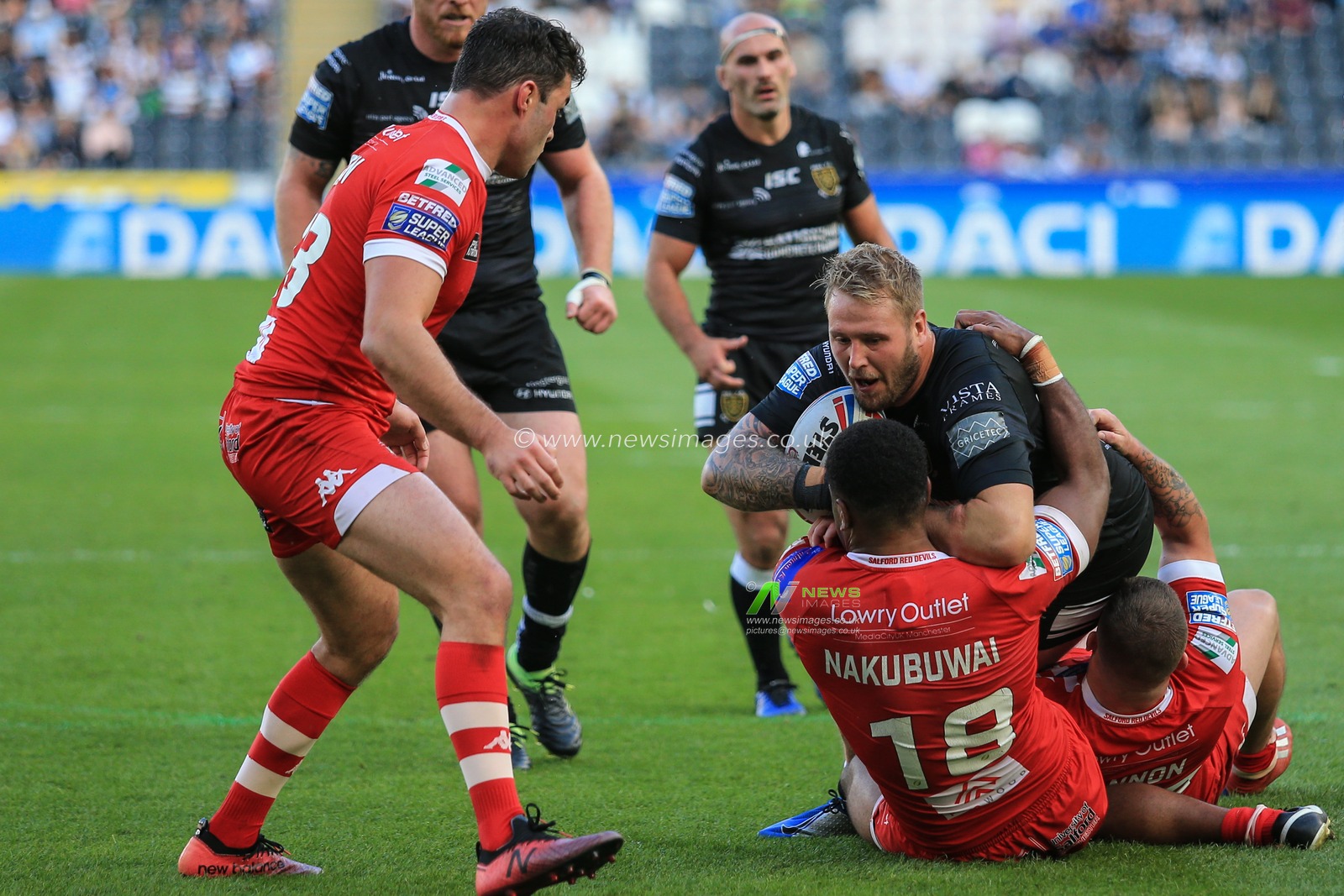 17th August 2019 , KCOM Stadium, Hull, England;  Betfred Super League, Round 26, Hull FC vs Salford Red Devils ; Joe Westerman (13) of Hull FC is tackled by Ben Nakubuwai (18) of Salford Red Devils 

Credit: David Greaves/News Images