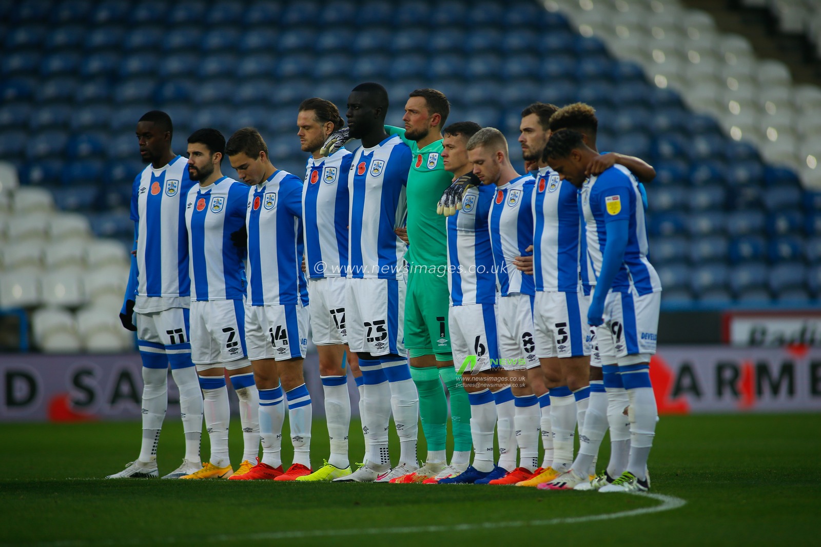 The Huddersfield Town  team line up ahead of kickoff to pause for a minutes silence in respect of Armistice Day (Remembrance day).