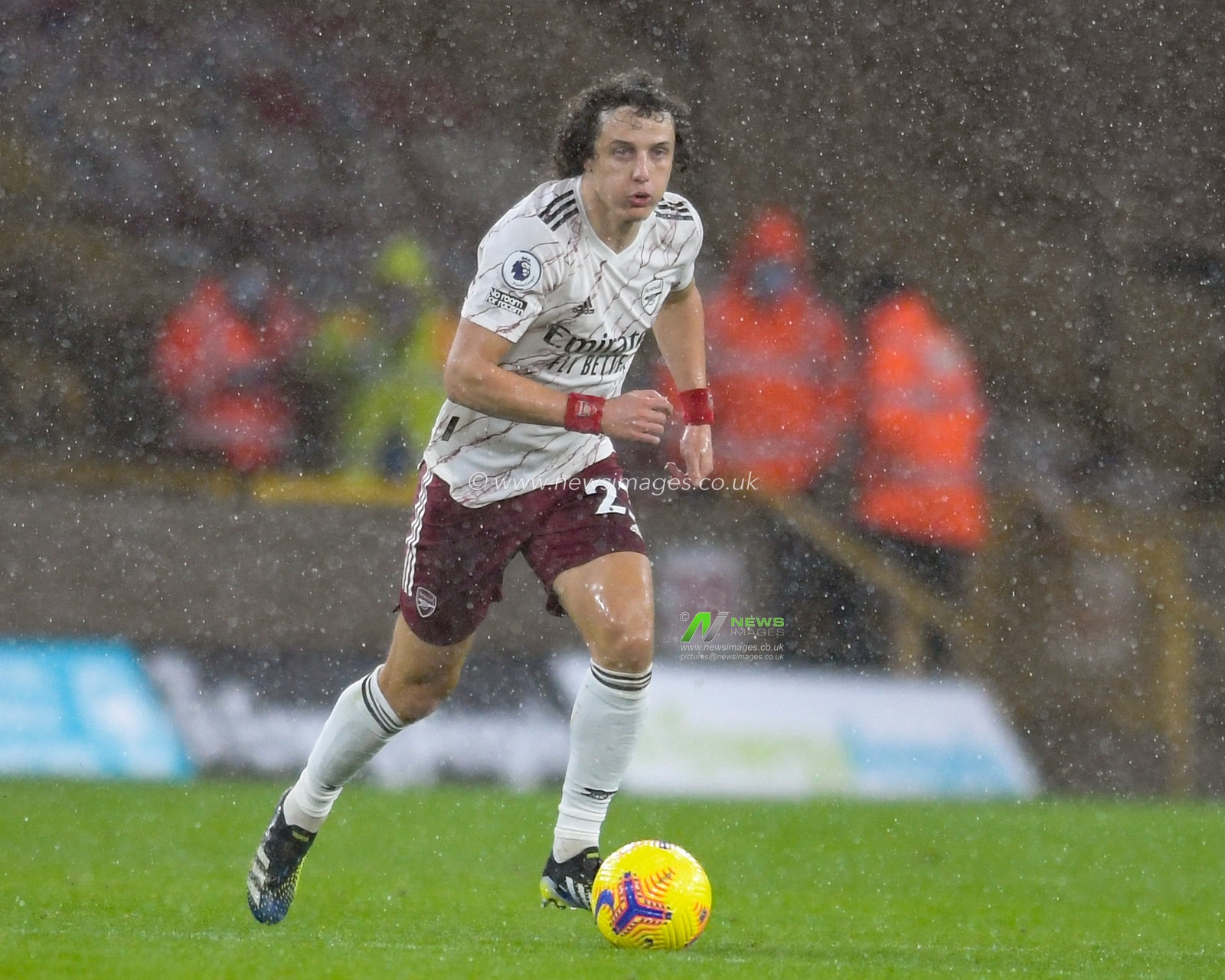David Luiz #23 of Arsenal runs forward with the ball in the rain