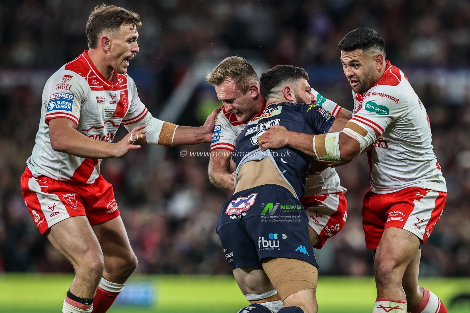Abbas Miski of Wigan Warriors is tackled by Jez Litten of Hull KR and Rhyse Martin of Hull KR during the 2025 Betfred Super League Grand Final Hull KR v Wigan Warriors at Old Trafford, Manchester, United Kingdom, 11th October 2025

(Photo by Alfie Cosgrove/News Images)