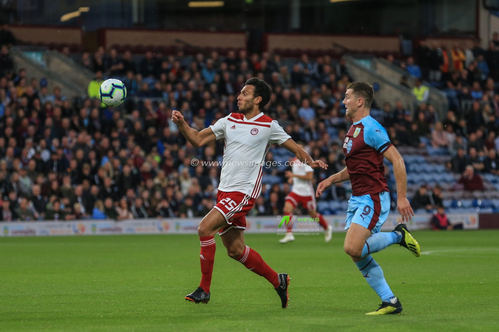 u30th August 2018, Turf Moor, Burnley, England; UEFA Europa League Play-off second leg Burnley v Olympiacos ; Roderick Miranda of Olympiacos clears the ball from Sam Vokes (09) of Burnley