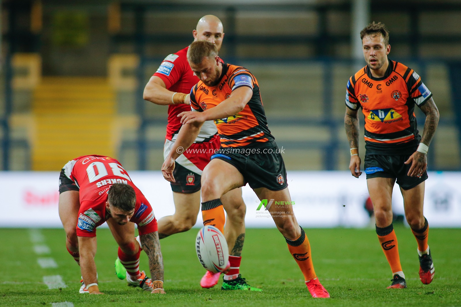 Danny Richardson (7) of Castleford Tigers kicks in general play against Salford Red Devils.