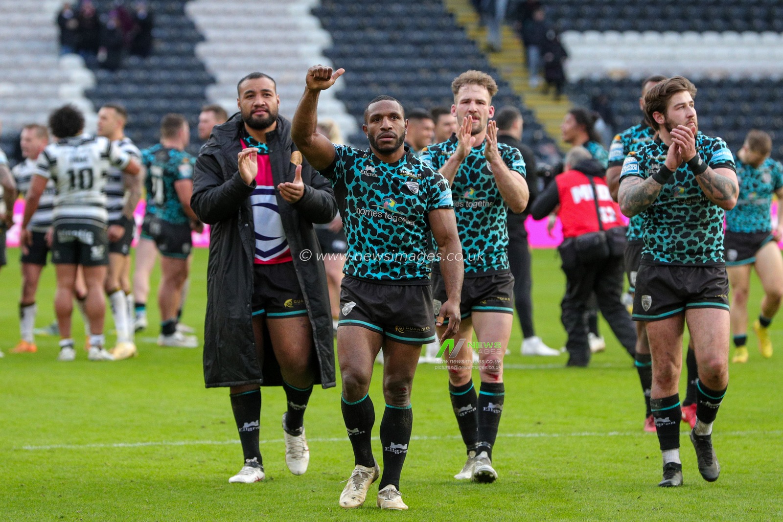 The Leigh Leopards team celebrate the win in front of their travelling fans at full time after the Betfred Super League  Round 6 match Hull FC vs Leigh Leopards at MKM Stadium, Hull, United Kingdom, 25th March 2023

(Photo by James Heaton/News Images)