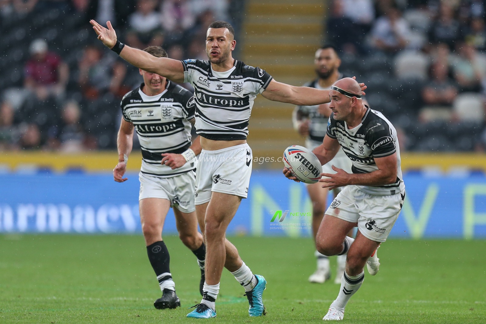 Carlos Tuimavave (3) of Hull FC appeals to referee Liam Moore  while Danny Houghton (9) of Hull FC runs with the ball