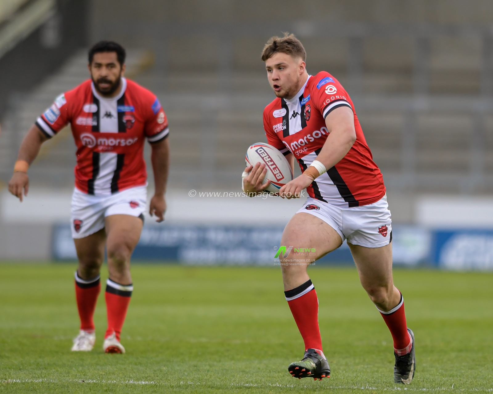 Jack Wells (26) of Salford Red Devils runs forward with the ball