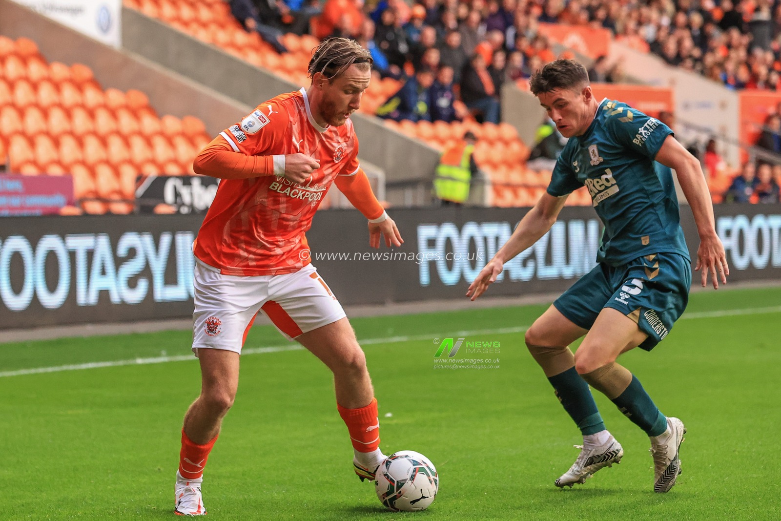 Josh Bowler #11 of Blackpool holds the ball as Jack Robinson #33 of Middlesbrough challenges
