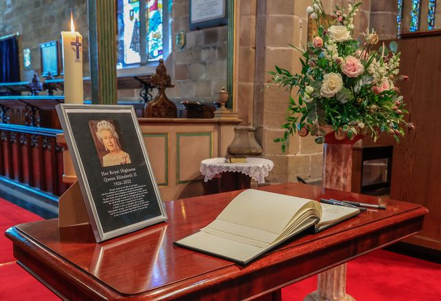 Locals signing the book of condolence at The Church of St Peter, Prestbury, Cheshire