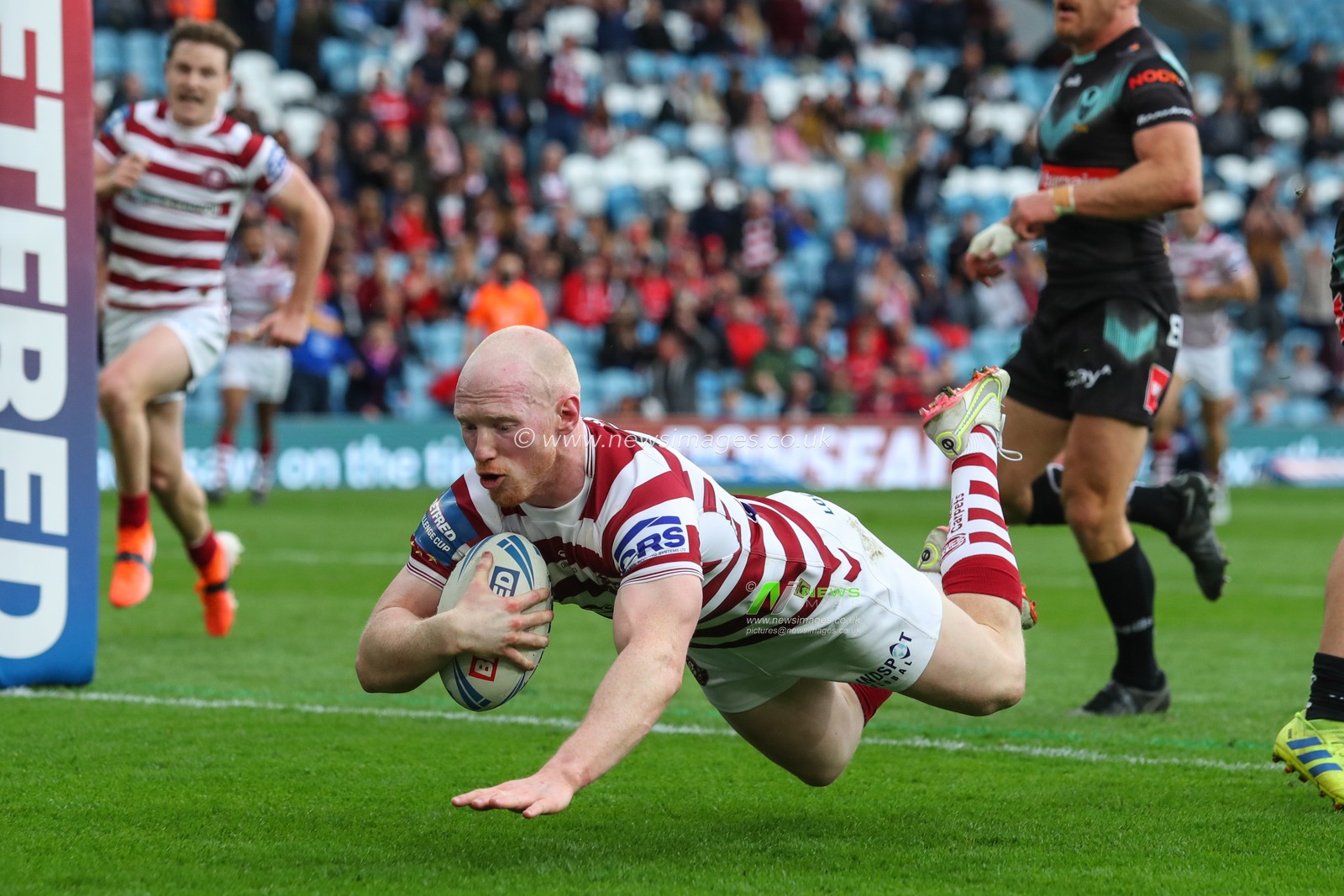 Liam Farrell #12 of Wigan Warriors goes over for a try to make it 12-0