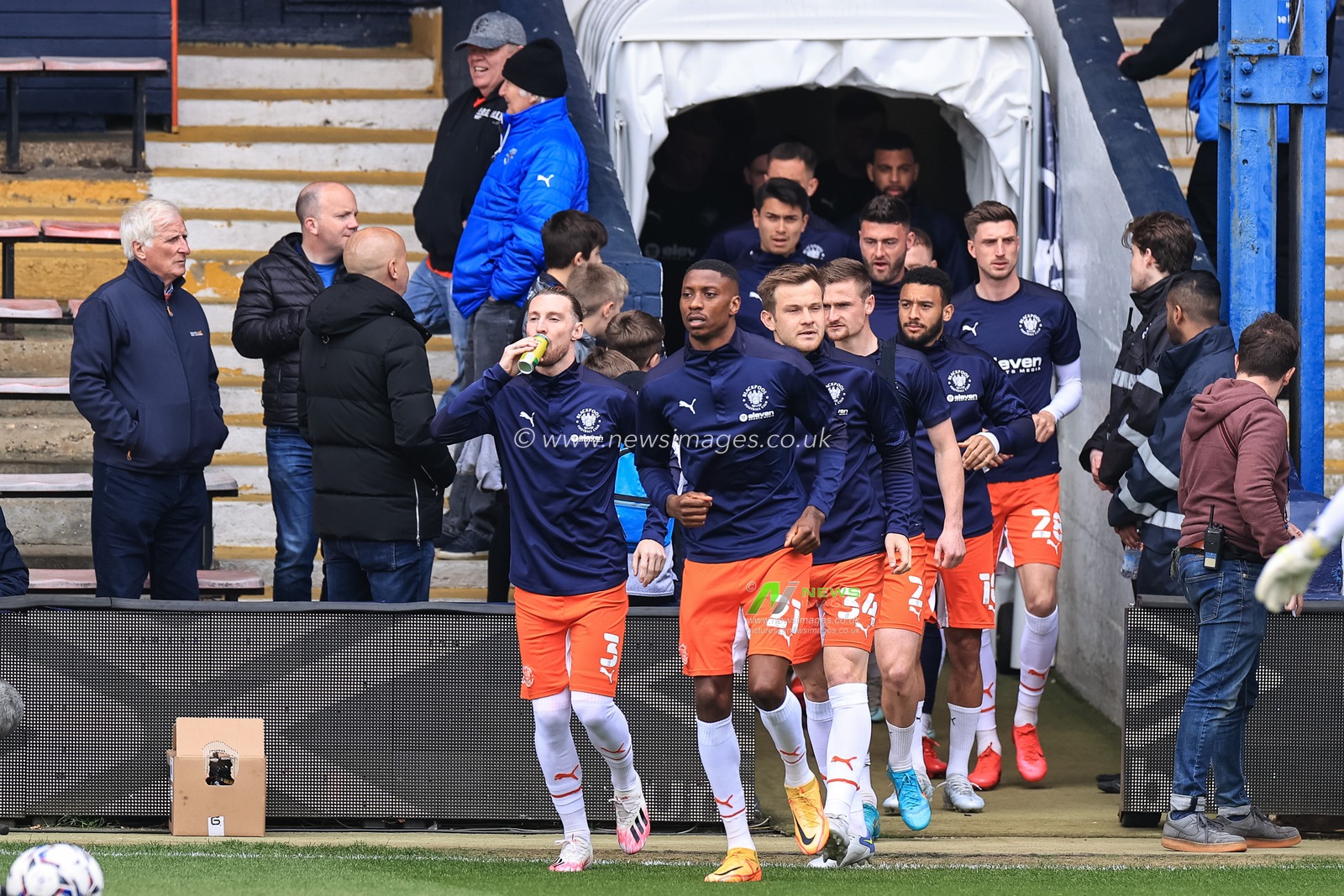 Marvin Ekpiteta #21 of Blackpool and team mates come out to warm up