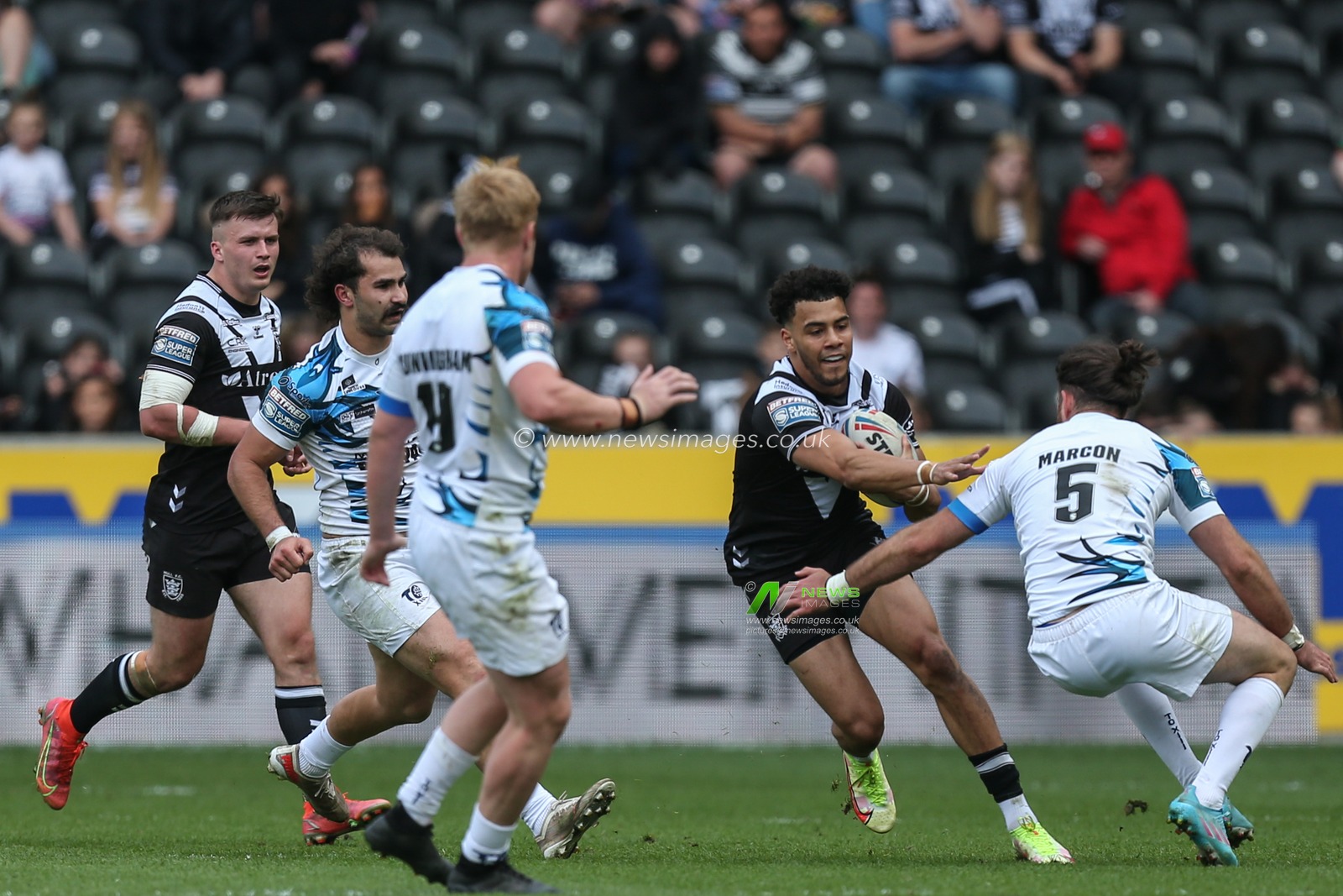Darnell McIntosh #5 of Hull FC runs at Paul Marcon #5 of Toulouse Olympique