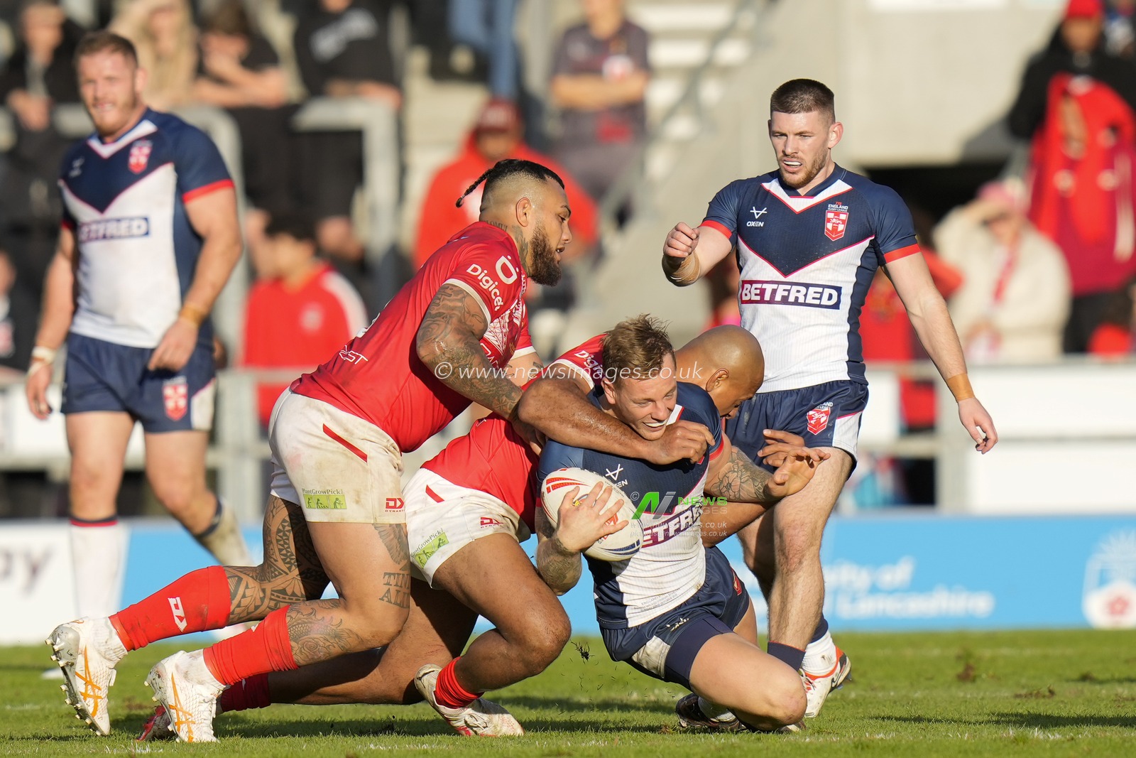 Felise Kaufusi #13 of Tonga tackles Tom Johnstone #5 of England during the Rugby League International match England vs Tonga at Totally Wicked Stadium, St Helens, United Kingdom, 22nd October 2023

(Photo by Steve Flynn/News Images)