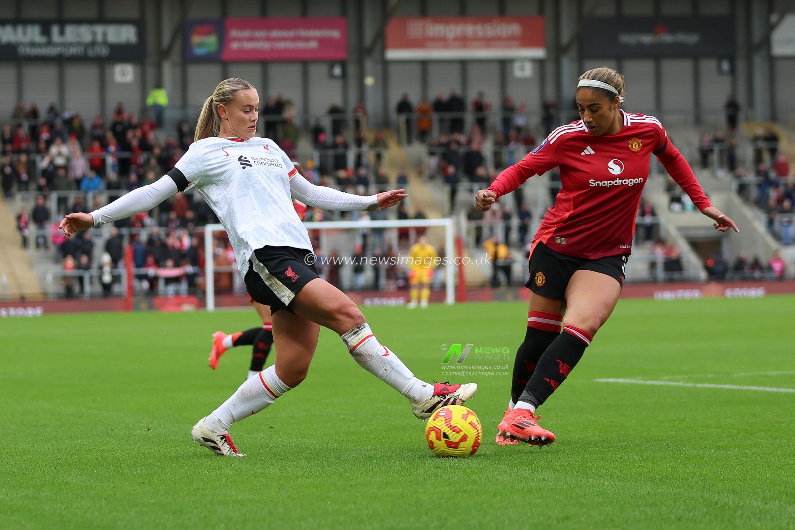 Zara Shaw of Liverpool is challenged by Gabby George of Manchester United of Manchester United during the Barclays Women's Super League match Manchester United Women vs Liverpool Women at Leigh Sports Village, Leigh, United Kingdom, 8th December 2024

(Photo by Alex Roebuck/News Images)