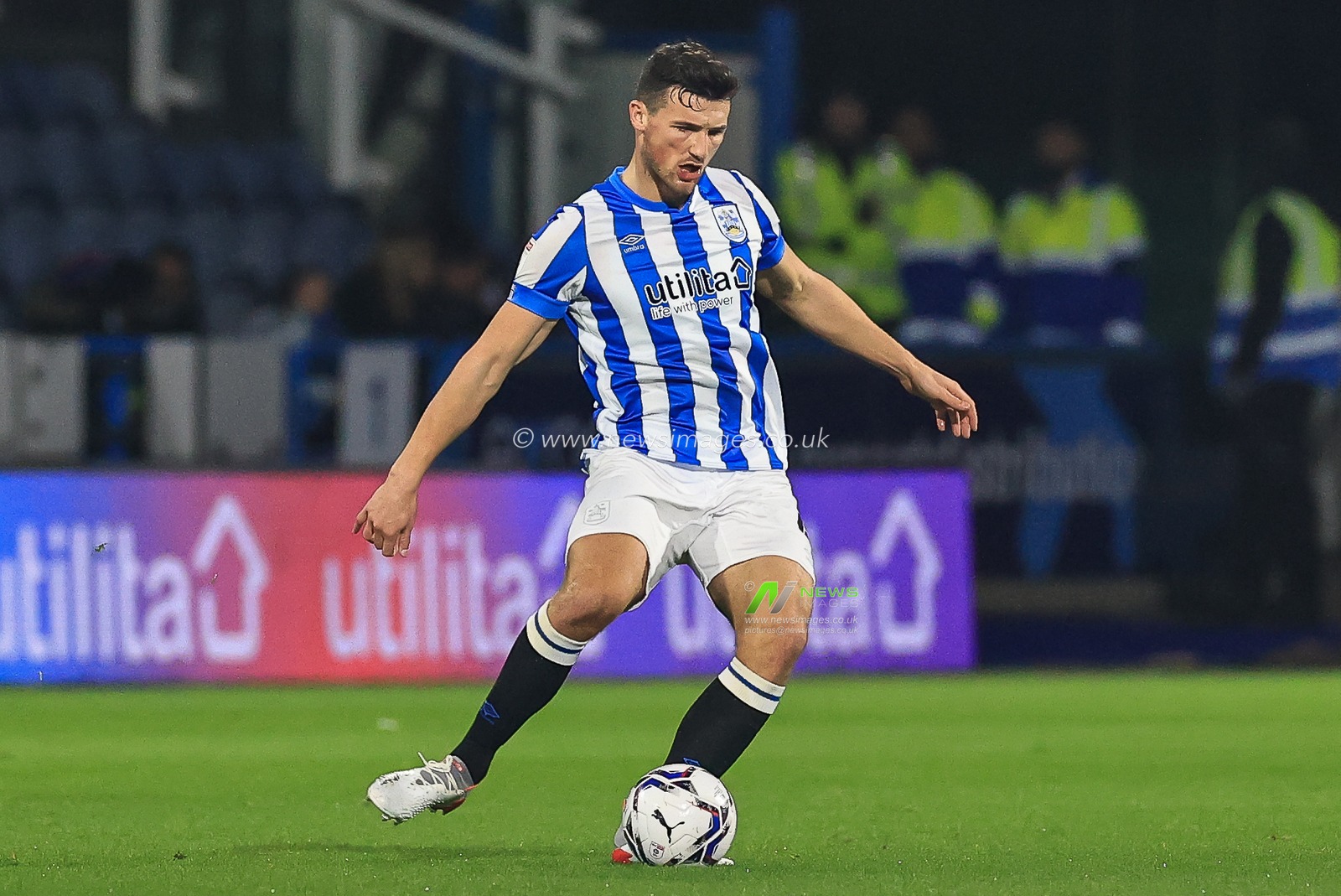 Matty Pearson #4 of Huddersfield Town passes the ball