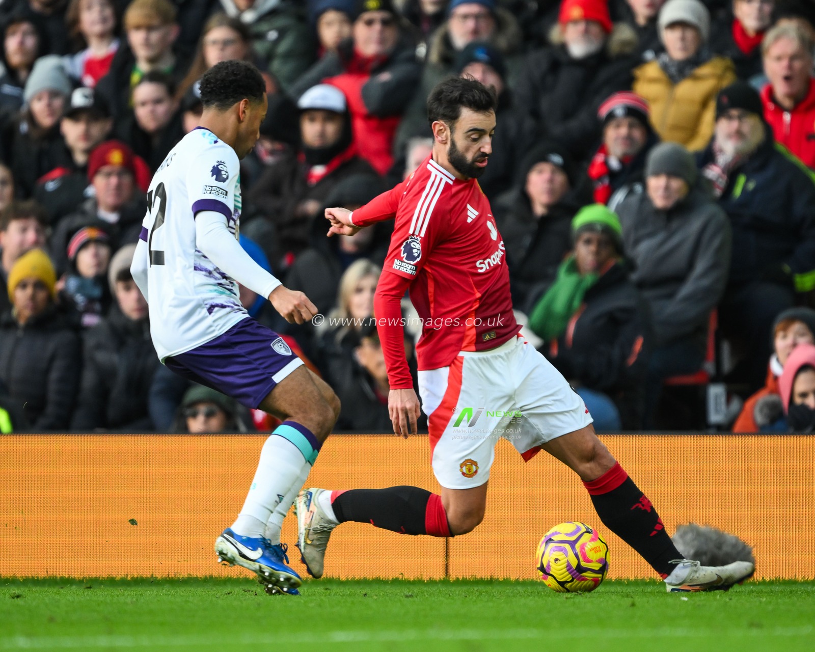 Bruno Fernandes of Manchester United makes a break with the ball past Tyler Adams of Bournemouth during the Premier League match Manchester United vs Bournemouth at Old Trafford, Manchester, United Kingdom, 22nd December 2024

(Photo by Craig Thomas/News Images)
