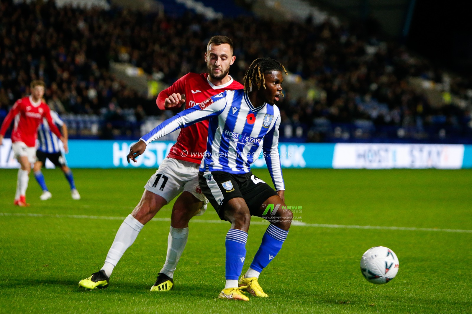 Dylan Connolly #11 of Morecambe and Alex Mighten #45 of Sheffield Wednesday during the Emirates FA Cup match Sheffield Wednesday vs Morecambe at Hillsborough, Sheffield, United Kingdom, 4th November 2022

(Photo by Ben Early/News Images)