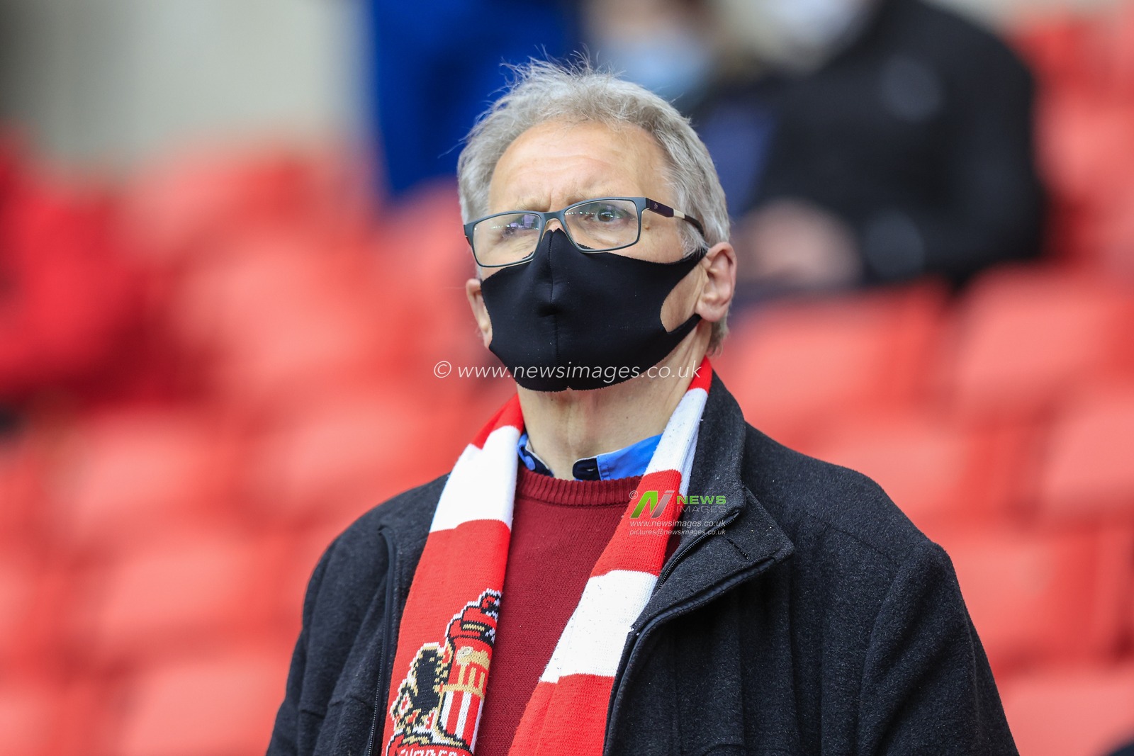 A Sunderland supporter watches on as 10,000 fans are allowed in to the Stadium of Light for the first time in 14 months