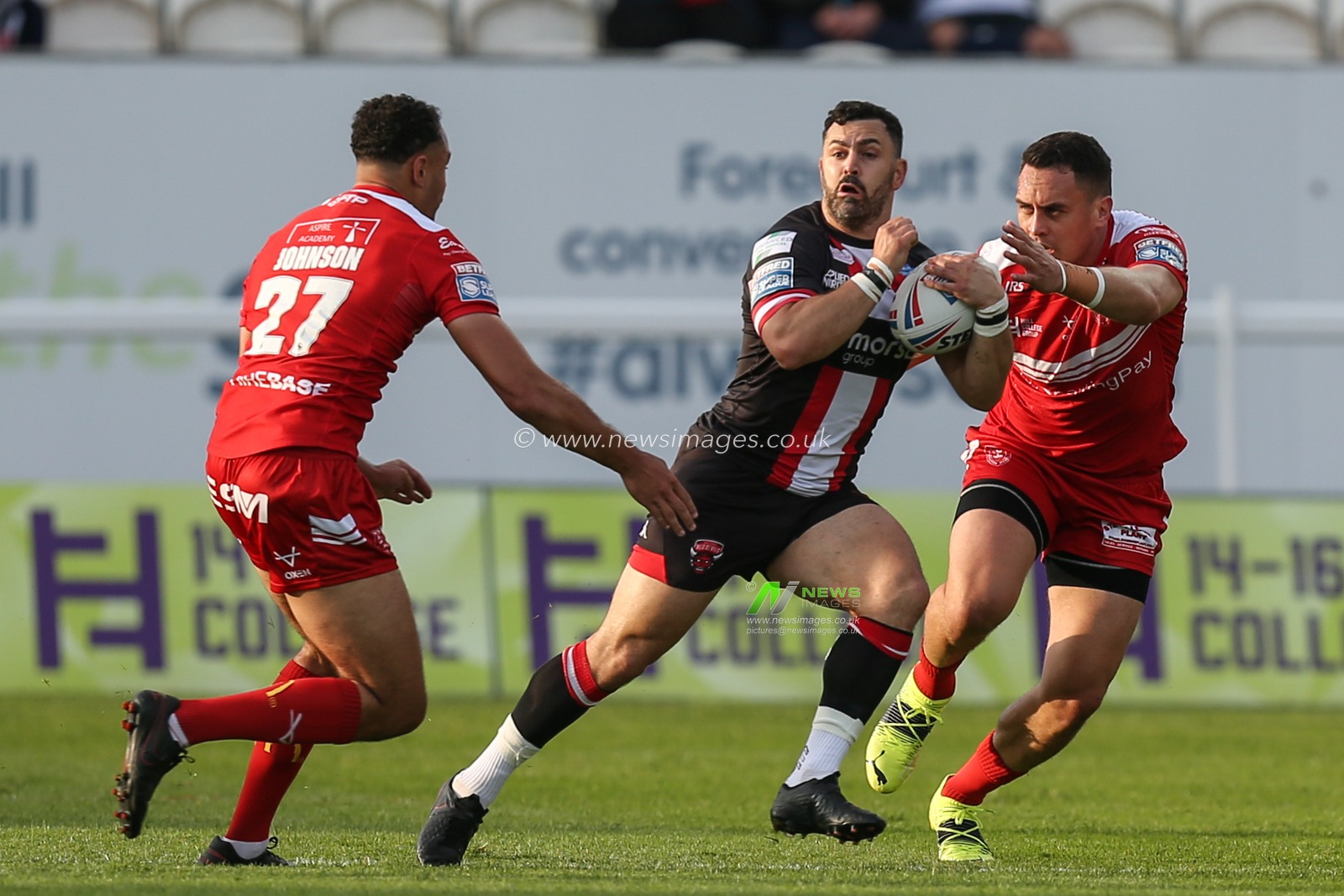Rhys Williams (22) of Salford Red Devils runs at the Hull KR defence