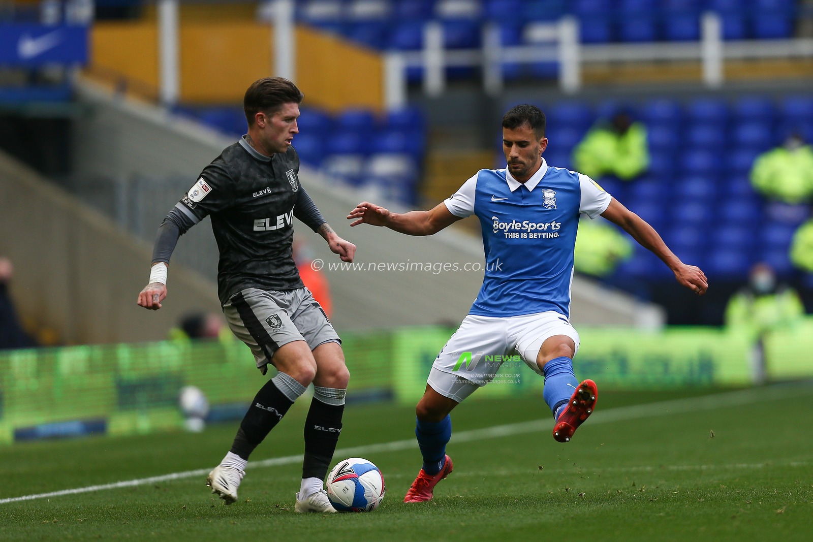 Joost van Aken (4) of Sheffield Wednesday is tackled by Maxime Colin (2) of Birmingham City