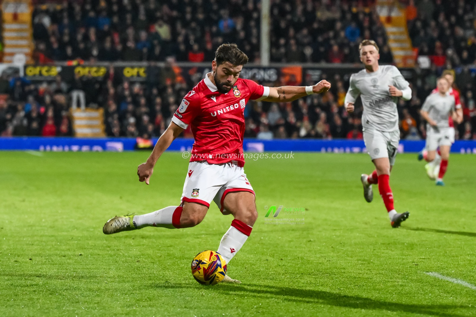 Elliot Lee of Wrexham crosses the ball during the Sky Bet League 1 match Wrexham vs Barnsley at SToK Cae Ras, Wrexham, United Kingdom, 3rd December 2024

(Photo by Craig Thomas/News Images)