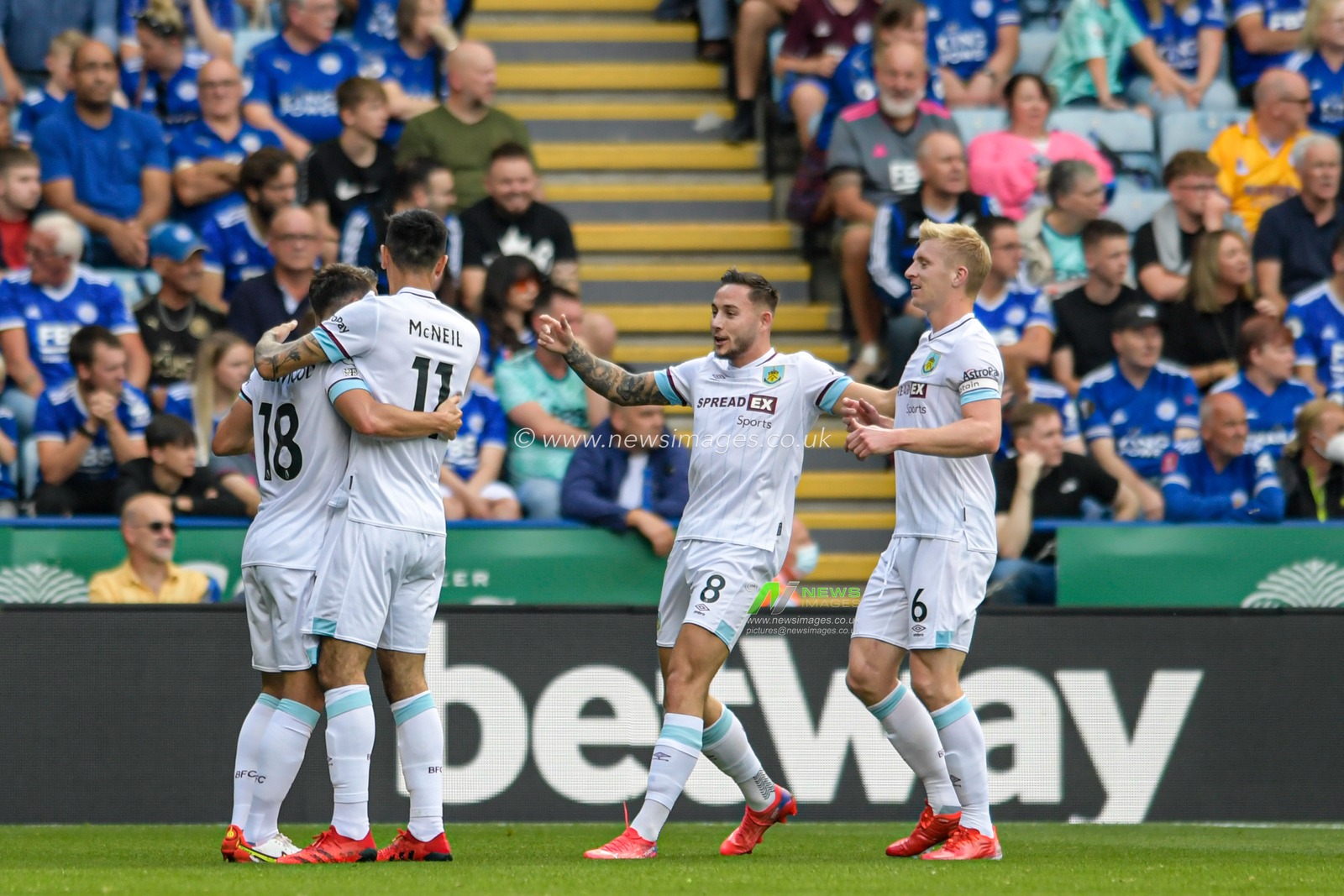 The Burnley players celebrate Jamie Vardy #9 of Leicester City scoring an own goal to make it 0-1