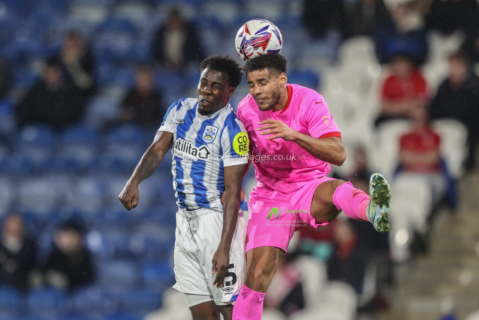 Jaheim Headley of Huddersfield Town and Kyran Lofthouse of Barnsley battle for the ball during the Bristol Street Motors Trophy match Huddersfield Town vs Barnsley at John Smith's Stadium, Huddersfield, United Kingdom, 8th October 2024

(Photo by Alfie Cosgrove/News Images)