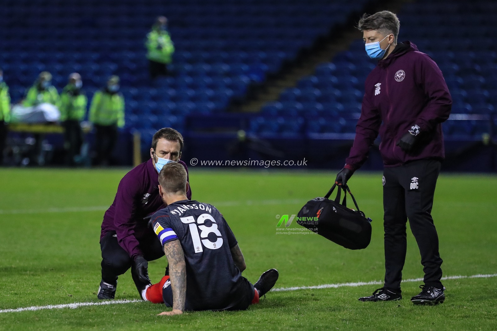 Pontus Jansson (18) of Brentford goes down injured and receives medical attention