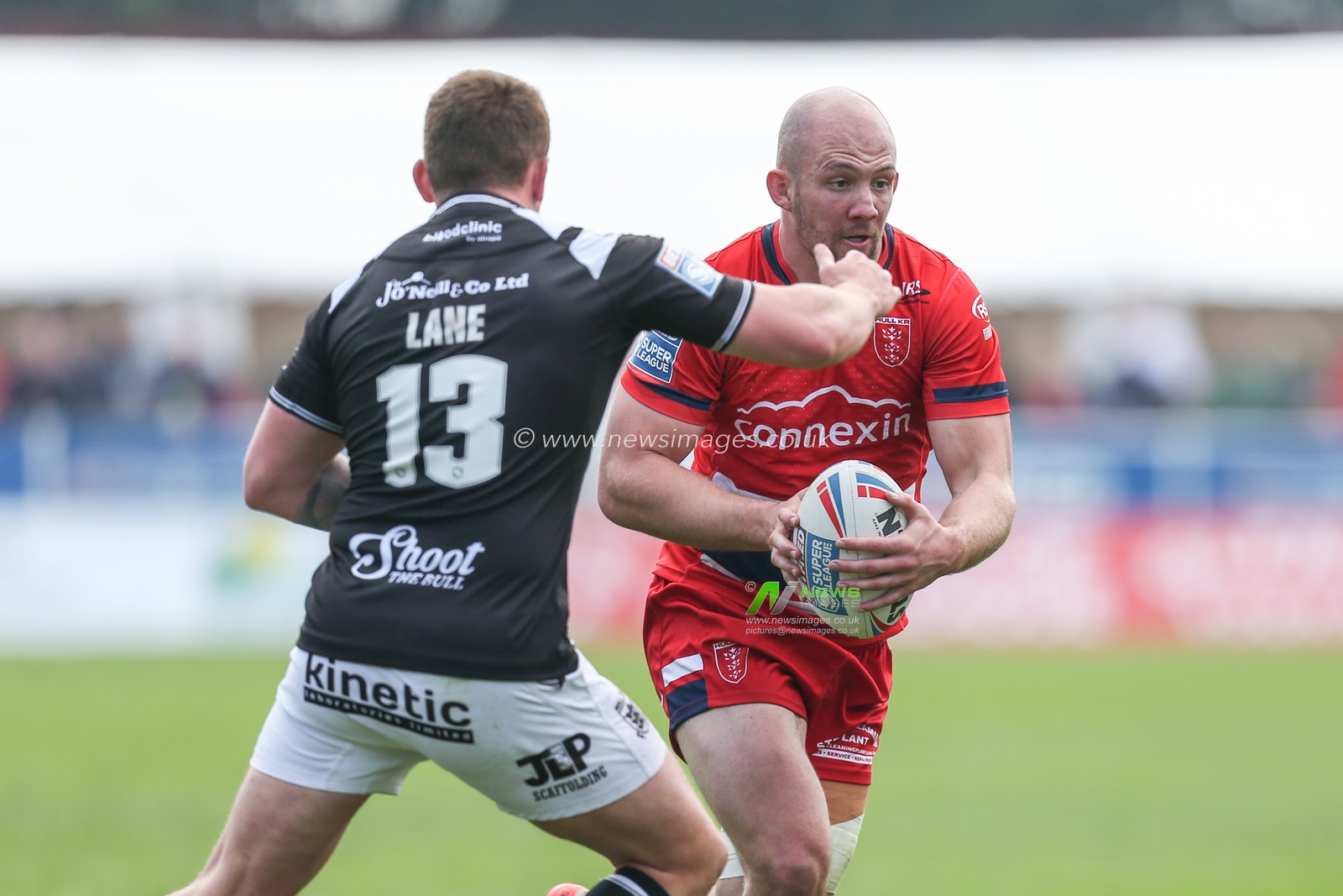George King #10 of Hull KR looks to go past Jordan Lane #13 of Hull FC
