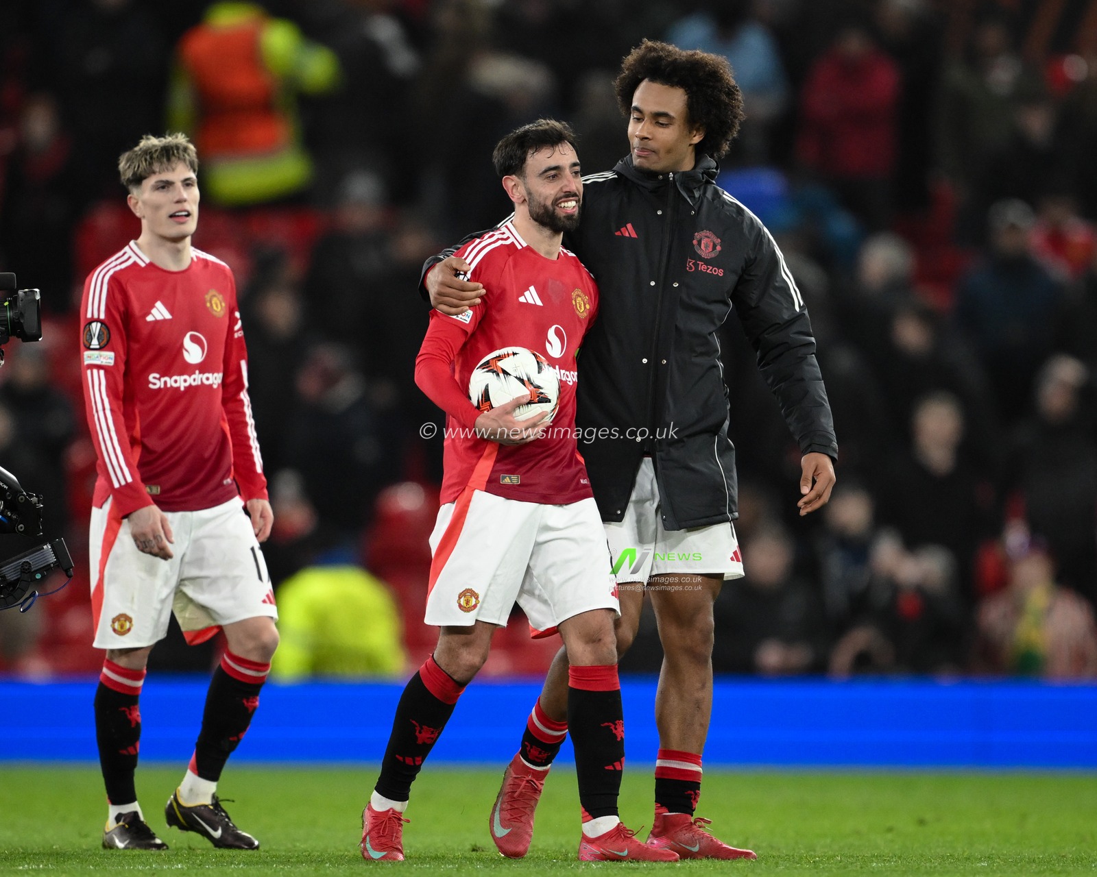Joshua Zirkzee embraces Bruno Fernandes of Manchester United after he collects the match ball after scoring a hat-trick during the UEFA Europa League Last 16 match Manchester United vs Real Sociedad at Old Trafford, Manchester, United Kingdom, 13th March 2025

(Photo by Craig Thomas/News Images)