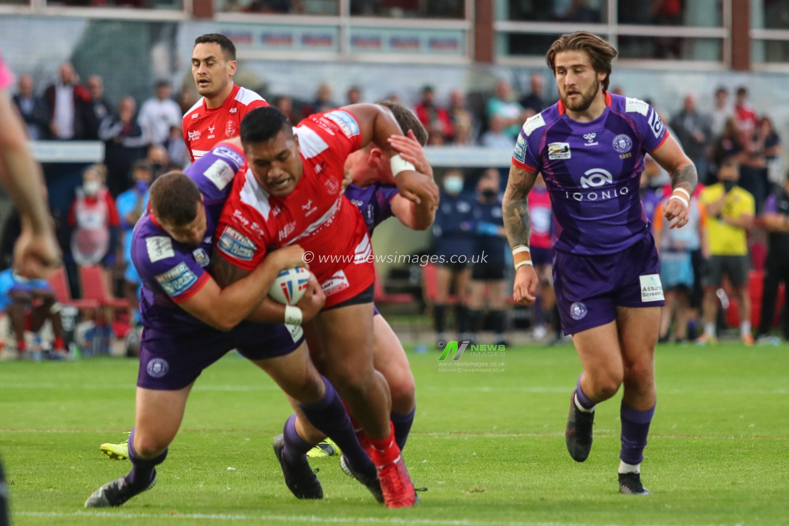 Albert Vete (8) of Hull KR is tackled by Tony Clubb (17) of Wigan Warriors