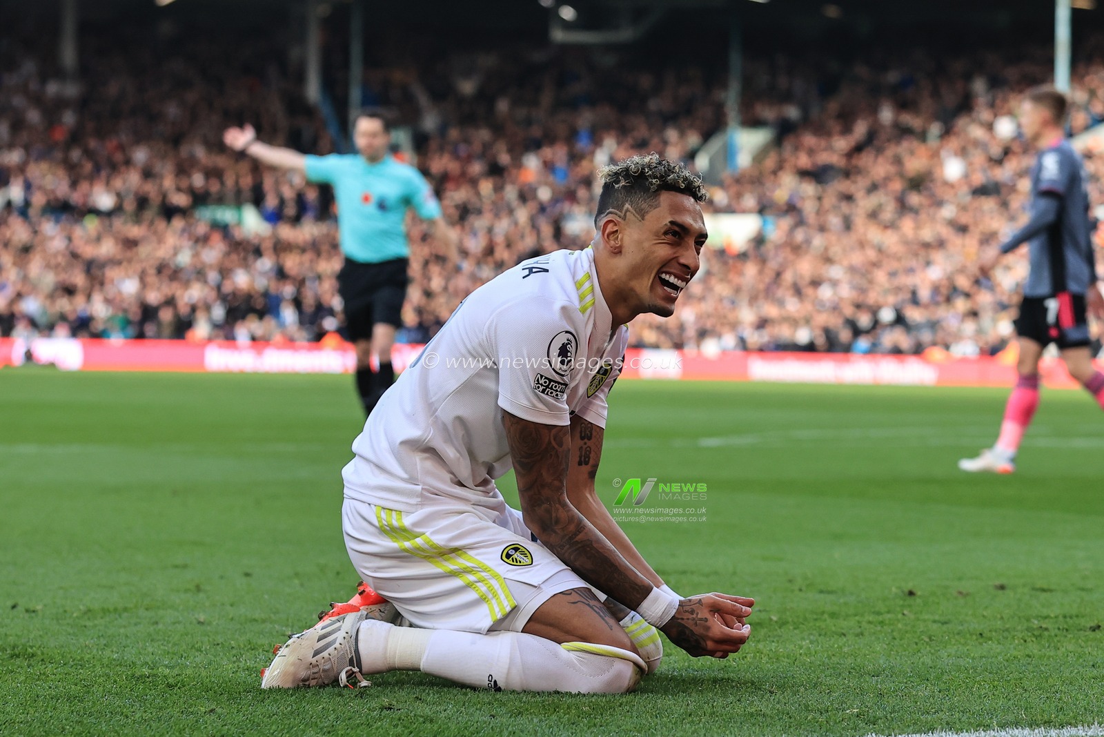Raphinha #10 of Leeds United reacts as heâ€™s brought down in the penalty area, referee Darren England gives Leicester a free-kick