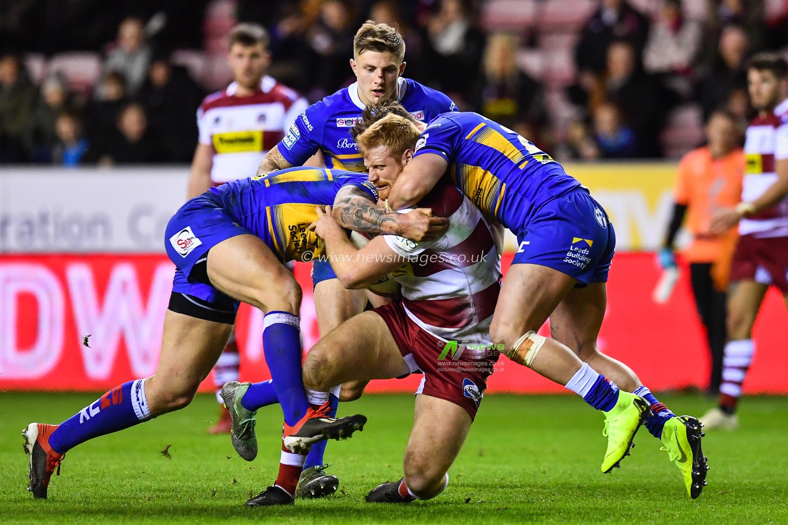 8th February  2019 , DW Stadium, Wigan, England;  Betfred Super League, Round 2, Wigan Warriors vs Leeds Rhinos ; Joe Bullock (22) of Wigan Warriors is tackled by Tom Briscoe (2) of Leeds Rhinos 

Credit: Craig Thomas/News Images