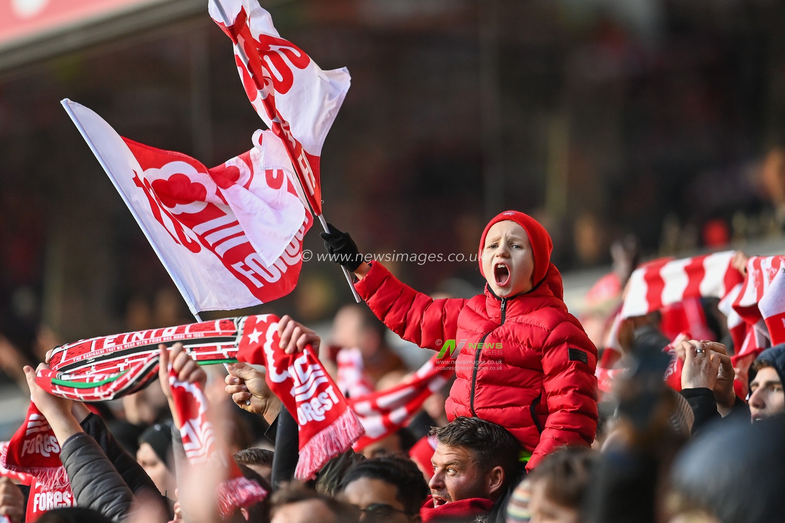 A young Nottingham Forest sings and waves his flag before the kick off