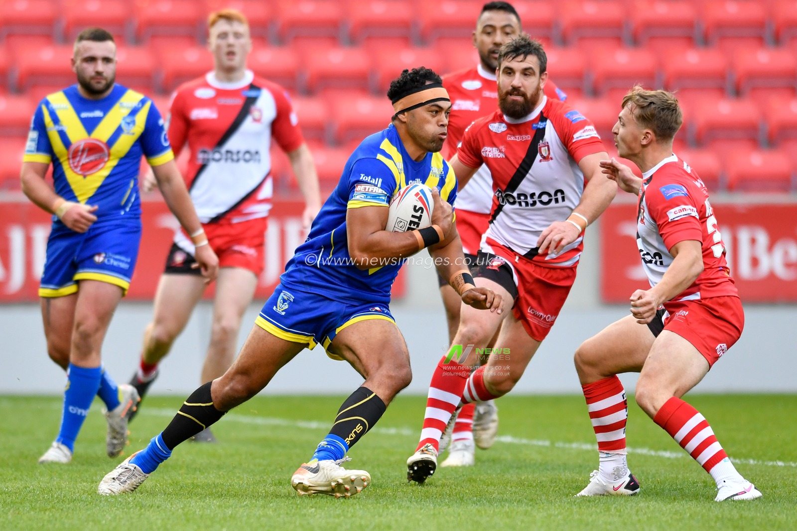 Sitaleki Akauola (18) of Warrington Wolves attempts to run the ball out of defence