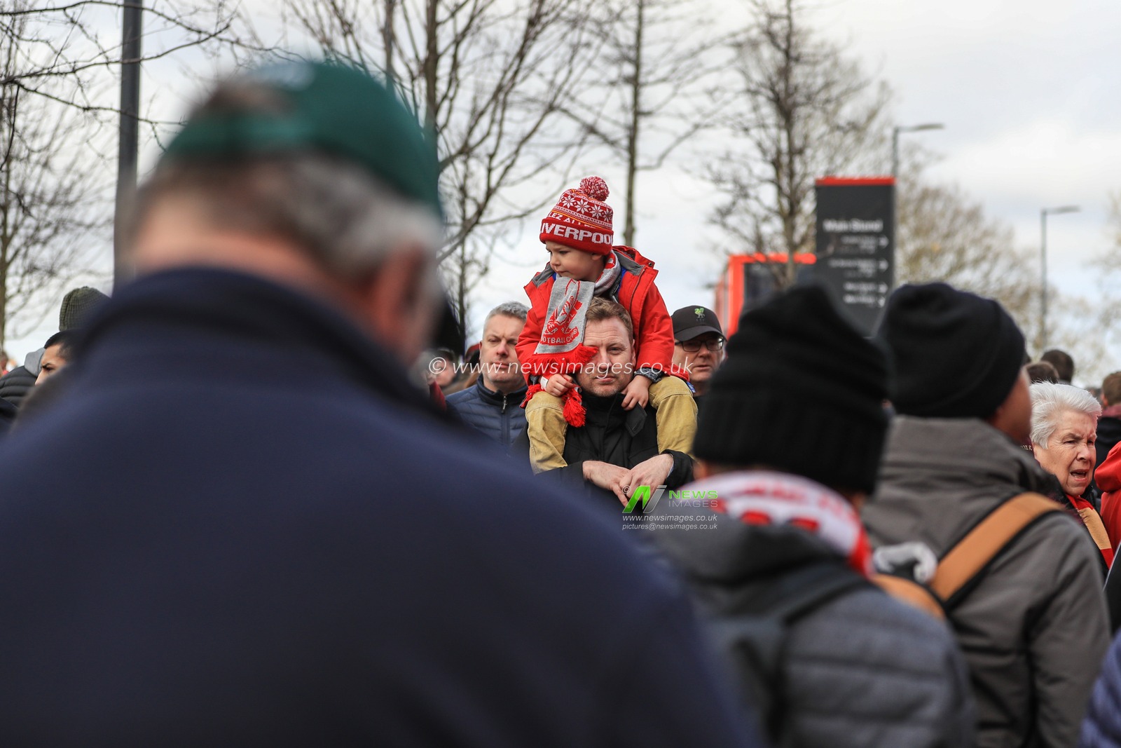 7th March 2020, Anfield, Liverpool, England; Premier League, Liverpool v Bournemouth : A young Liverpool fan rides his dadâ€™s shoulders outside Anfield