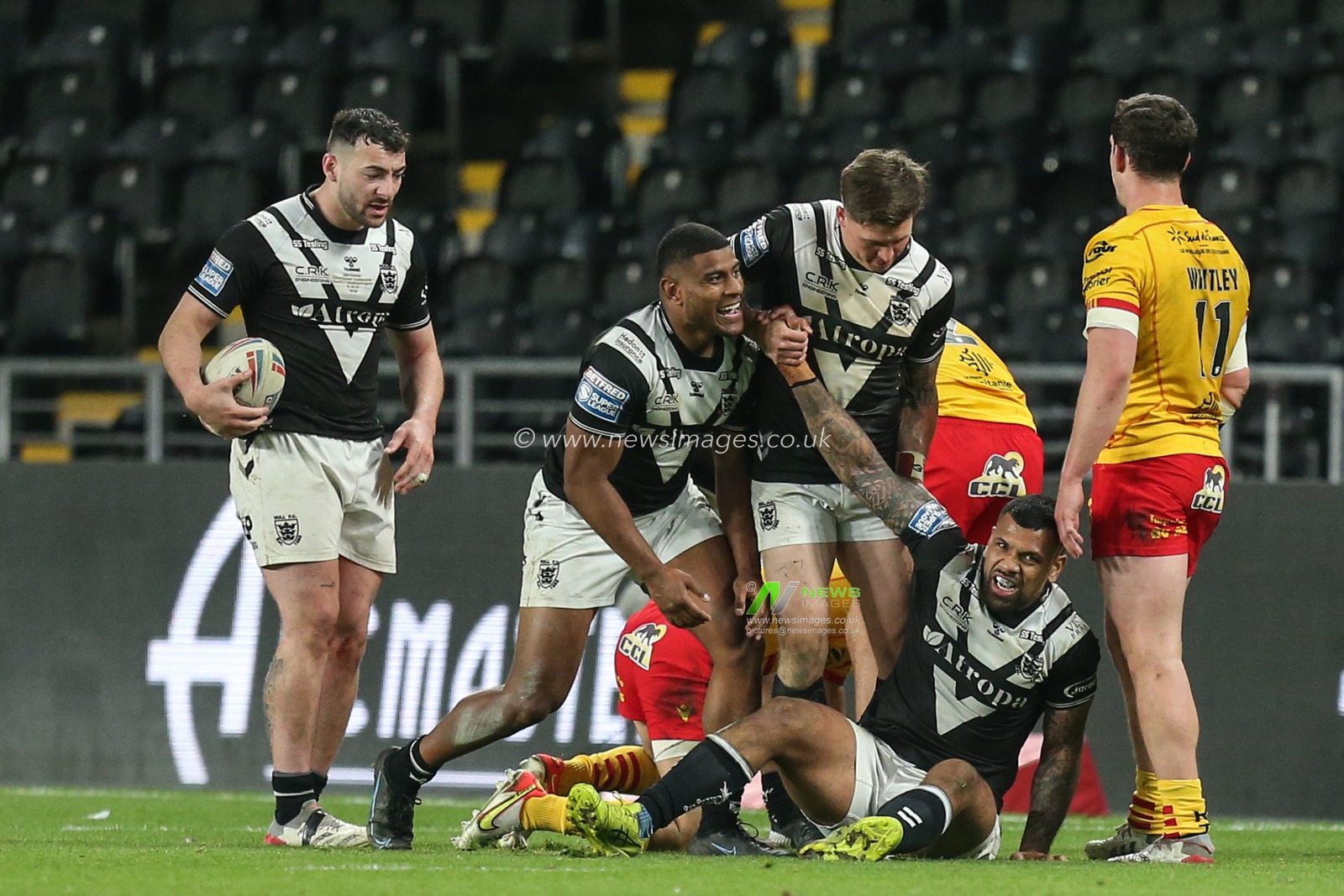 Smiles from Manu Ma'u #12 of Hull FC and Joe Lovodua #14 of Hull FC after the tackle that secured the victory over Catalans