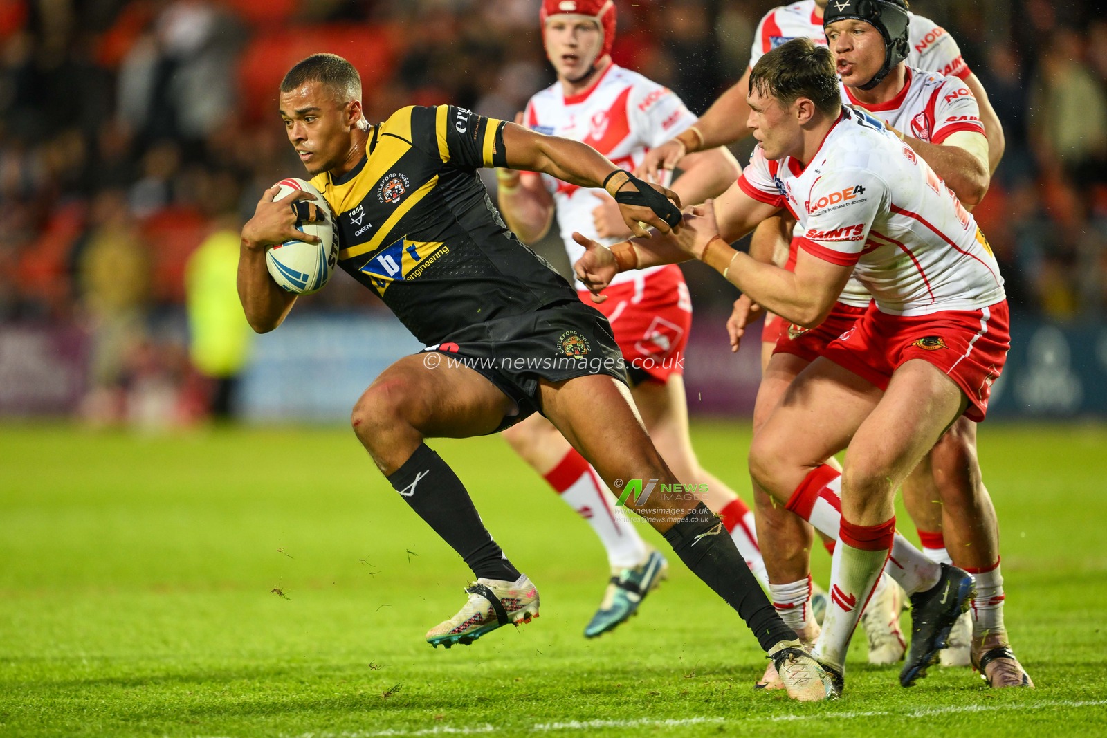 Corey Hall of Castleford Tigers  breaks the tackle of Ben Davies of St. Helens during the Betfred Super League Round 16 match St Helens vs Castleford Tigers at Totally Wicked Stadium, St Helens, United Kingdom, 5th July 2024

(Photo by Craig Thomas/News Images)