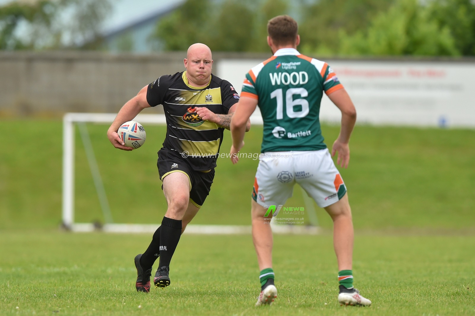 Brad Brennan of North Wales Crusaders ahead of Danny King (16) of Hunslet RLFC