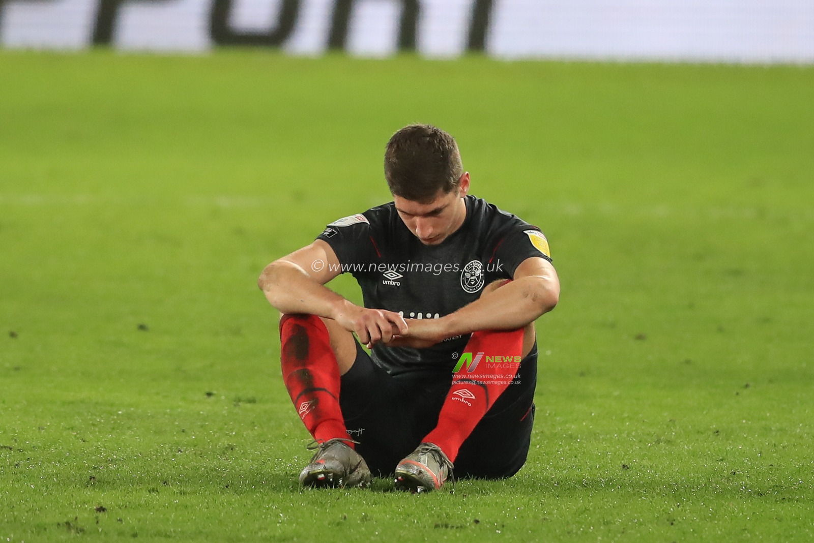 Vitaly Janelt #27 of Brentford sits down on the pitch looking dejected after Brentford throw away a two goal lead as they draw 2-2 with Derby