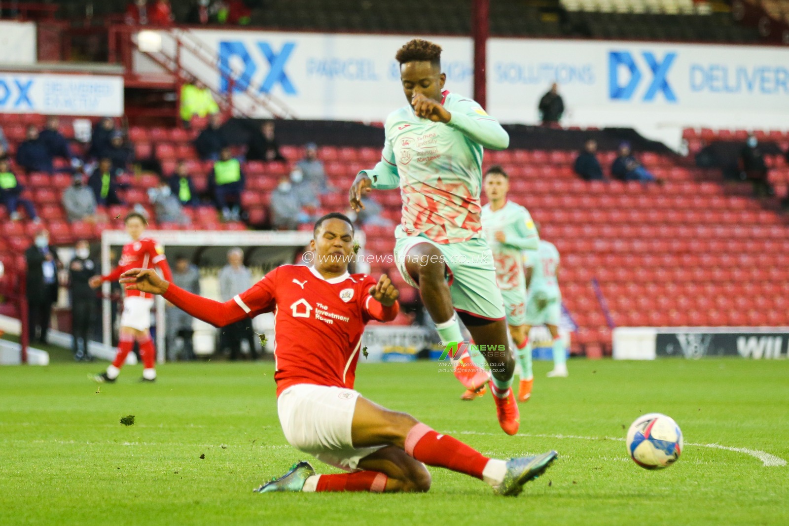 Toby Sibbick #20 of Barnsley and Jamal Lowe #9 of Swansea City battle for the ball