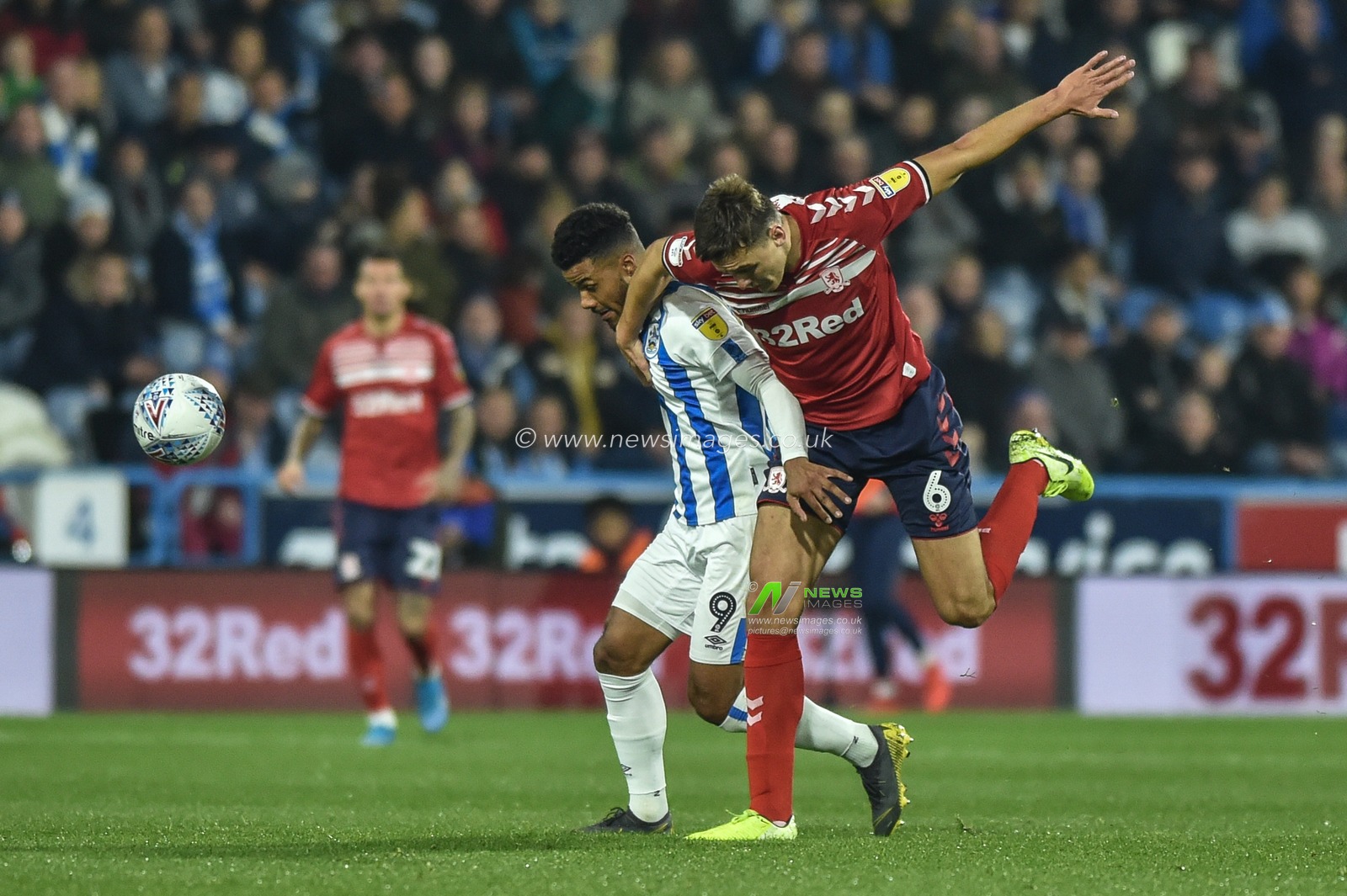 23rd October 2019, John Smith's Stadium, Huddersfield, England; Sky Bet Championship, Huddersfield Town v Middlesbrough :Elias Kachunga (9) of Huddersfield Town  and Dael Fry (6) of Middlesborough challenge for ball.

Credit: Dean Williams/News Images