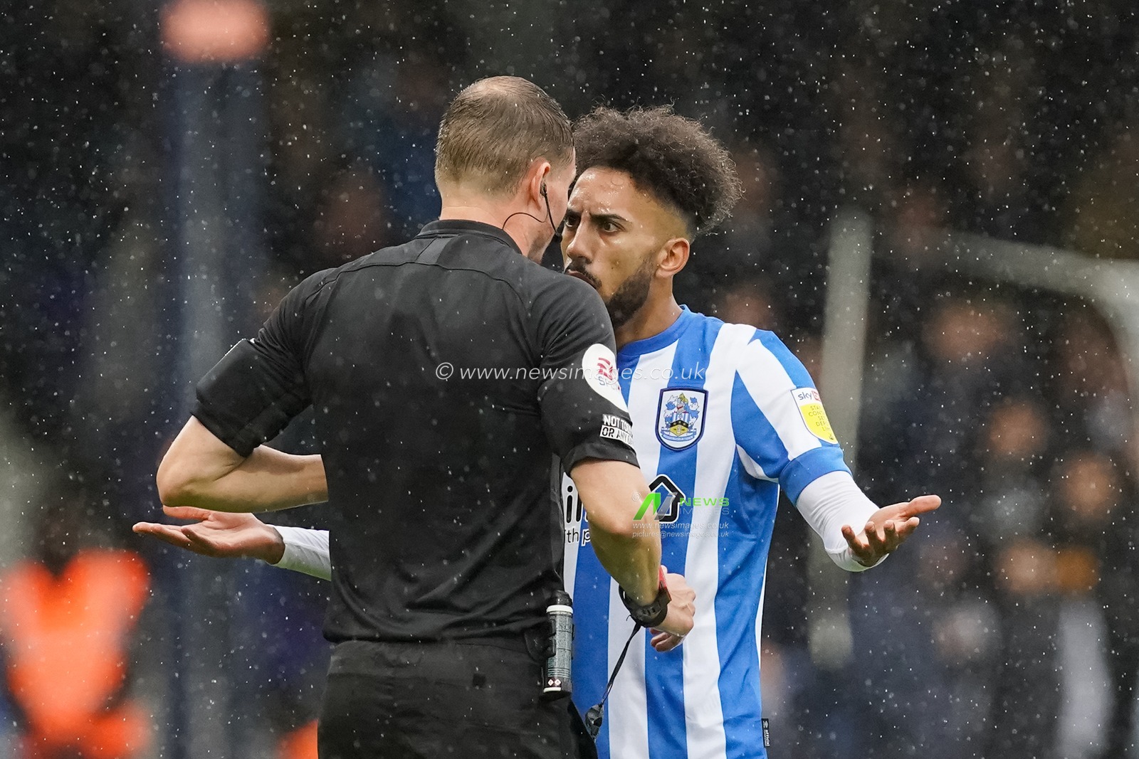 Sorba Thomas #16 of Huddersfield Town complains to the referee Leigh Doughty regarding Glen Rea #6 of Luton Town foul who gets a yellow card