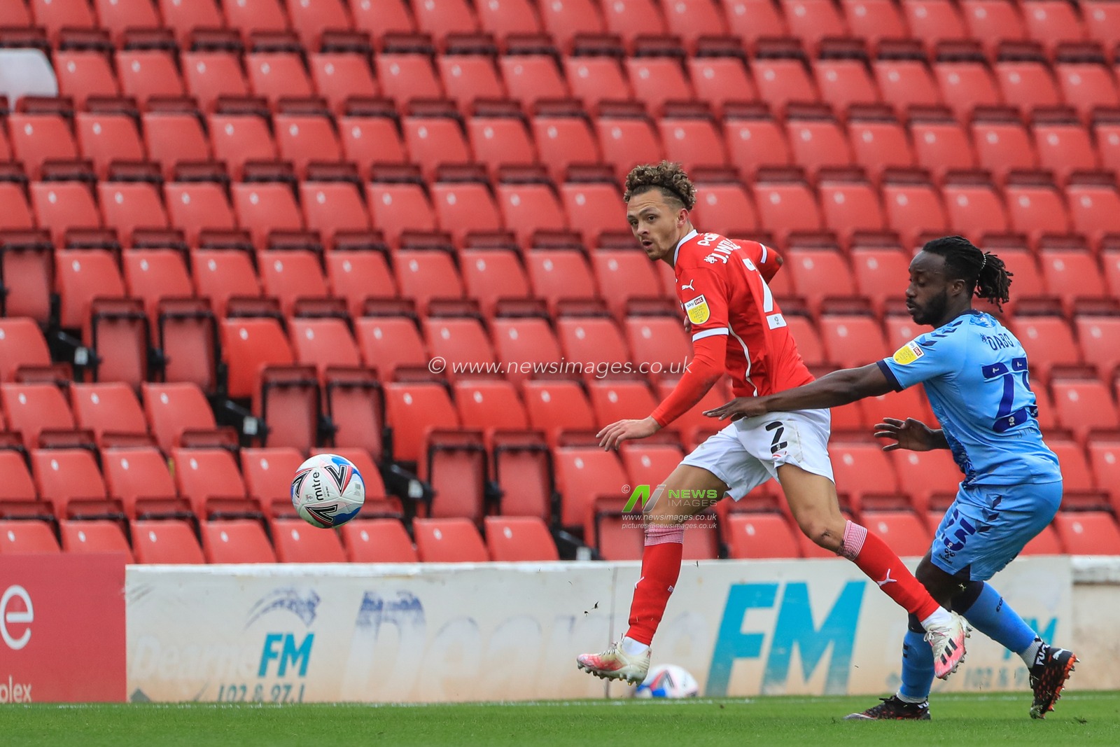 Jordan Williams (2) of Barnsley clears the Balla s Fankaty Dabo (23) of Coventry City pressures