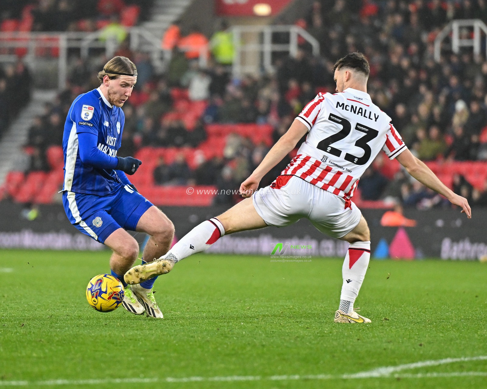 Josh Bowler 14# of Cardiff City Association Football Club drives the ball forward while being challenge by Luke McNally 23# of Stoke City Football Club, during the Sky Bet Championship match Stoke City vs Cardiff City at Bet365 Stadium, Stoke-on-Trent, United Kingdom, 4th November 2023

(Photo by Cody Froggatt/News Images)