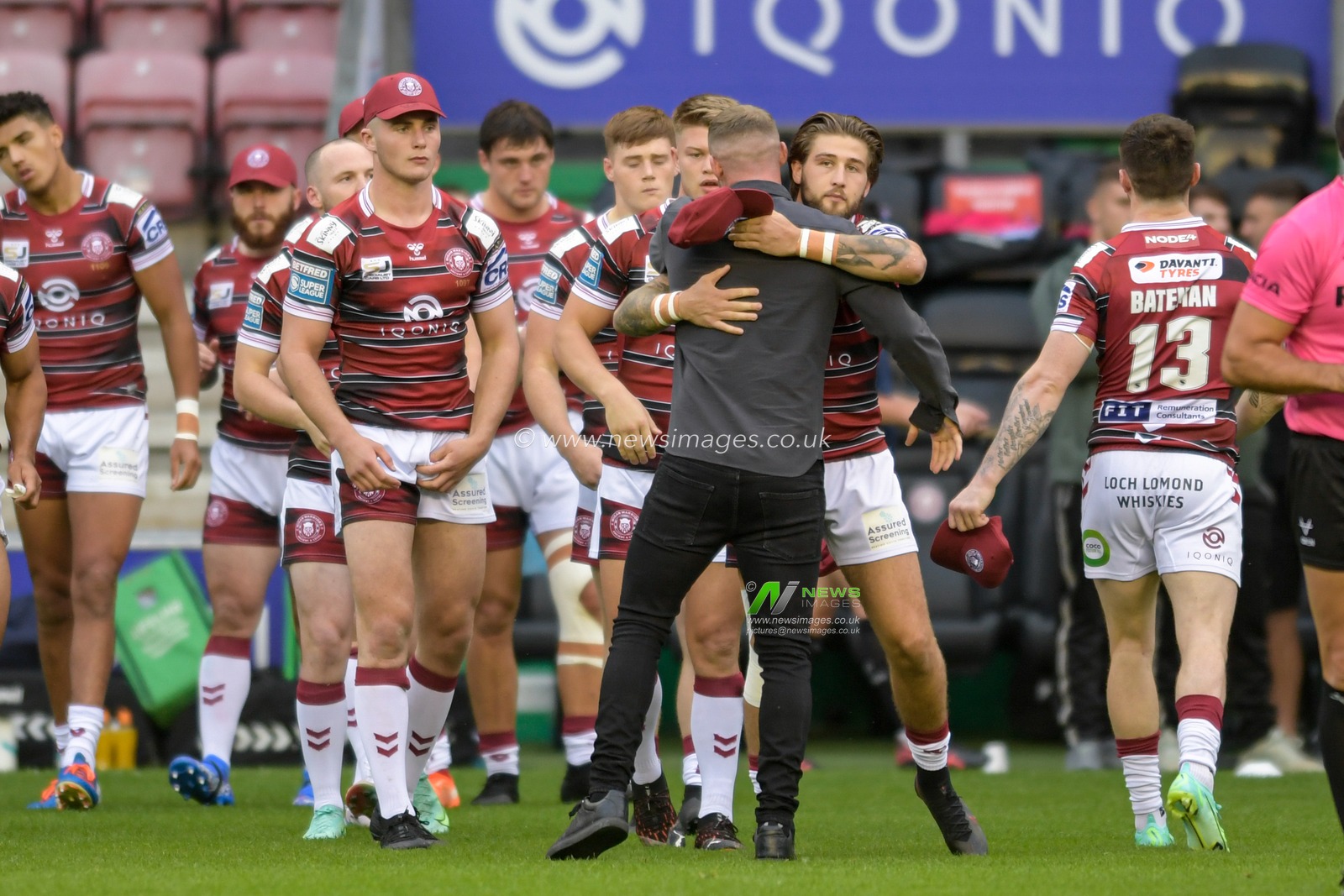 Dom Manfredi of Wigan Warriors hugs Joe Shorrocks (25) of Wigan Warriors after receiving a guard of honour after announcing his retirement from the game