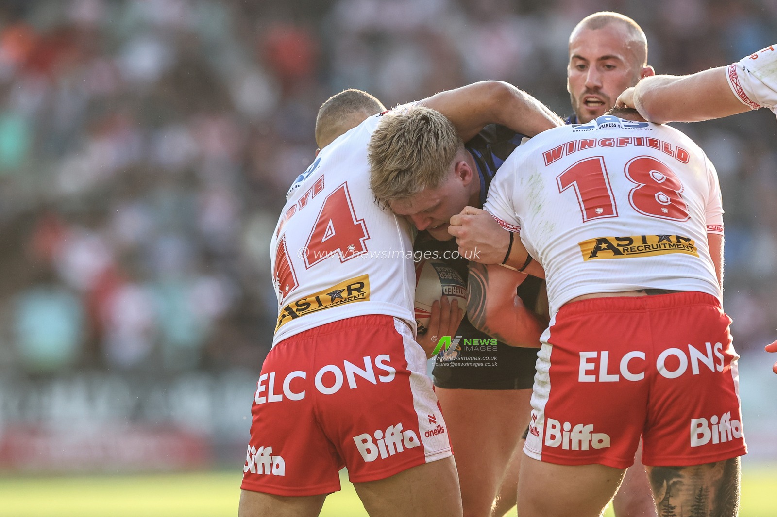 James McDonnell of Leeds Rhinos is tackled by Moses Mbye of St. Helens and Jake Wingfield of St. Helens during the Betfred Super League round 15 match St Helens vs Leeds Rhinos at Totally Wicked Stadium, St Helens, United Kingdom, 20th June 2025

(Photo by Alfie Cosgrove/News Images)