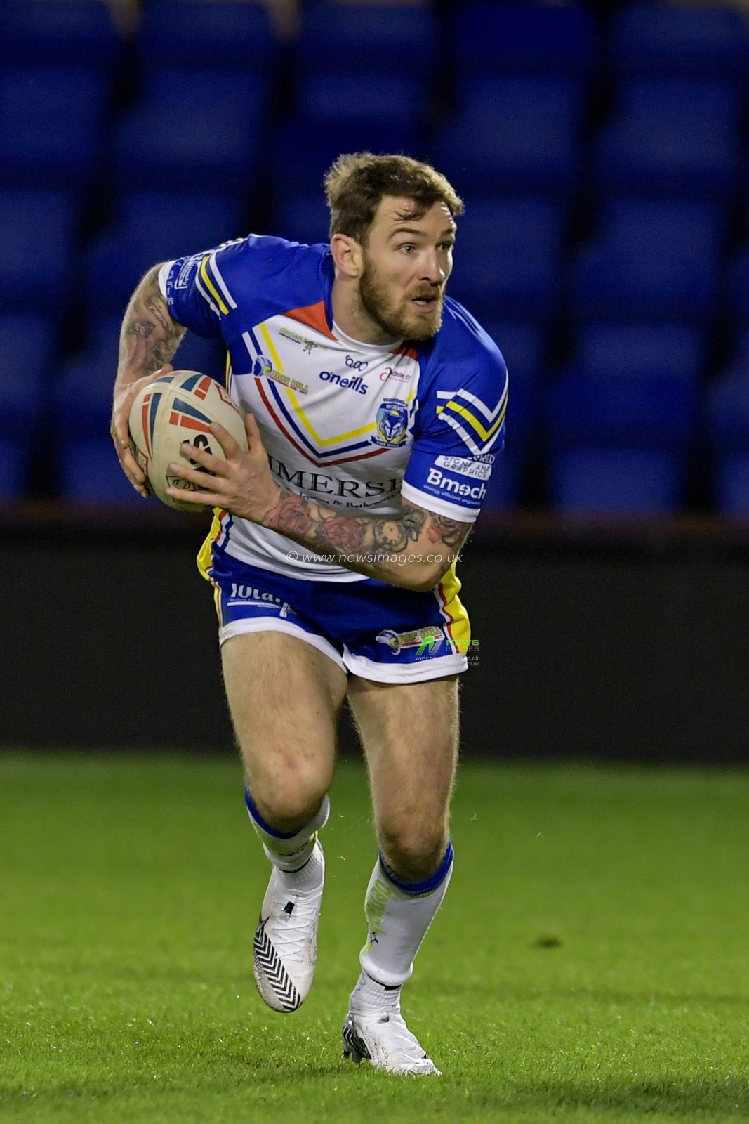 Daryl Clark (9) of Warrington Wolves runs with the ball