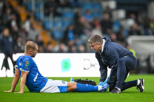 Sam Hughes of Stockport County receives treatment for an in jury during the Carabao Cup match Stockport County vs Blackburn Rovers at Edgeley Park Stadium, Stockport, United Kingdom, 13th August 2024

(Photo by Craig Thomas/News Images)