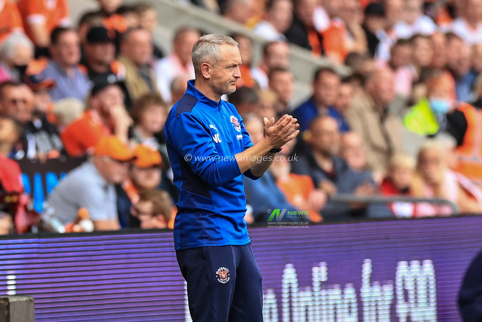 Neil Critchley Head Coach of Blackpool applauds his players during the game